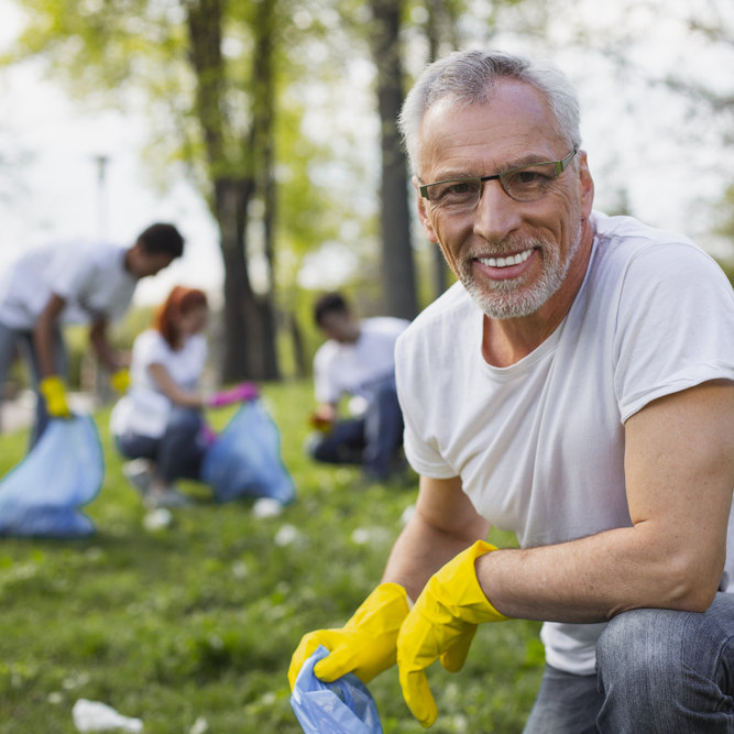 Work,As,Volunteer.,Experienced,Senior,Volunteer,Holding,Garbage,Bag,And