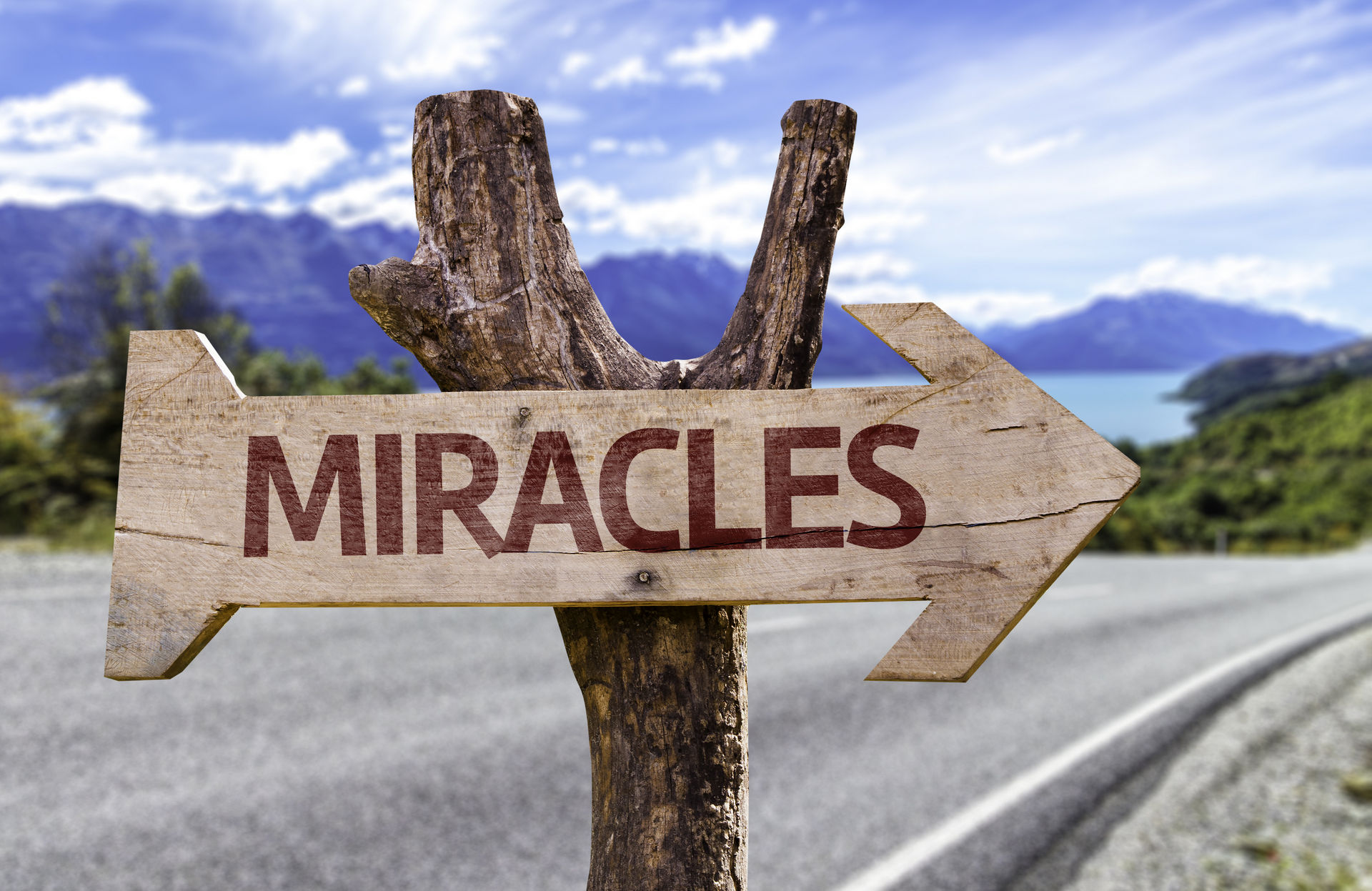 Miracles,Wooden,Sign,With,Landscape,Background